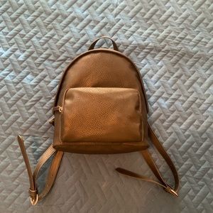 This is a black, faux leather backpack that is in perfect and unused condition.